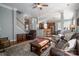 Open-concept living room with hardwood floors, comfortable seating and a view into the kitchen at 8532 Westmoreland Lake Dr, Cornelius, NC 28031