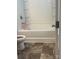 A bathroom featuring a shower and a toilet, partially visible through a door frame at 9340 Grand Valley Dr, Charlotte, NC 28213