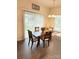 Cozy dining area with elegant lighting, a wooden table, and sliding door access to the outdoors at 9340 Grand Valley Dr, Charlotte, NC 28213