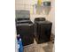 A laundry room features modern black front loading washer and dryer machines at 9340 Grand Valley Dr, Charlotte, NC 28213