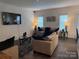A living room with neutral tones, layered textiles, a television, and two windows at 9340 Grand Valley Dr, Charlotte, NC 28213