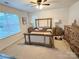 Spacious main bedroom with elegant wooden furniture and a ceiling fan at 9340 Grand Valley Dr, Charlotte, NC 28213