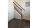 Carpeted staircase with decorative iron railing and natural light creates an elegant transition between floors at 9340 Grand Valley Dr, Charlotte, NC 28213