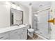 Bathroom featuring large mirror, granite counters, and seamless glass shower at 9640 Heartwood Ln, Mint Hill, NC 28227