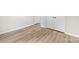 Bright bedroom featuring modern vinyl flooring, crisp white walls, and closet doors at 9640 Heartwood Ln, Mint Hill, NC 28227
