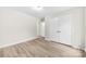 Neutral bedroom featuring modern vinyl flooring, crisp white walls, and closet at 9640 Heartwood Ln, Mint Hill, NC 28227