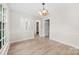Bright dining room with hardwood floors and classic chandelier at 9640 Heartwood Ln, Mint Hill, NC 28227