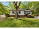 Charming single-story home with a well-maintained lawn and mature tree in a tranquil, wooded setting at 9640 Heartwood Ln, Mint Hill, NC 28227