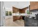 Traditional kitchen featuring tile flooring, wooden cabinets, and updated appliances at 9640 Heartwood Ln, Mint Hill, NC 28227