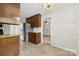 Well-lit kitchen with stainless steel appliances, tile floors, and wooden cabinets at 9640 Heartwood Ln, Mint Hill, NC 28227