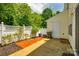 Private backyard features a small patio area, fence, and mature trees at 975 Copperstone Ln, Fort Mill, SC 29708