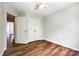 Bright bedroom features hardwood floors, neutral paint, closet, and ceiling fan at 975 Copperstone Ln, Fort Mill, SC 29708