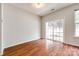 Spacious room featuring hardwood floors and sliding glass door to outdoor at 975 Copperstone Ln, Fort Mill, SC 29708