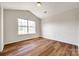 Bright bedroom with hardwood floors and a large window providing lots of natural light at 975 Copperstone Ln, Fort Mill, SC 29708
