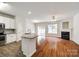 Open-concept living room and kitchen with hardwood floors and a fireplace feature at 975 Copperstone Ln, Fort Mill, SC 29708