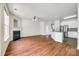 Inviting living room featuring a fireplace, ceiling fan, and hardwood floors leading to the kitchen with stainless steel appliances at 975 Copperstone Ln, Fort Mill, SC 29708