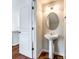 Stylish powder room featuring a pedestal sink, decorative mirror, and updated fixtures at 975 Copperstone Ln, Fort Mill, SC 29708