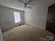 This bedroom features a ceiling fan and a window at 1001 Bexley Ln, Lincolnton, NC 28092
