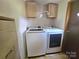 Laundry room with washer, dryer, and overhead cabinets at 1001 Bexley Ln, Lincolnton, NC 28092