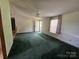 This living room has a ceiling fan, a window, and an exterior door at 1001 Bexley Ln, Lincolnton, NC 28092