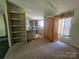 Living room with carpet, light fixtures, and a bookcase at 1001 Bexley Ln, Lincolnton, NC 28092