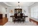 Formal dining room featuring hardwood floors, elegant lighting, and detailed trim at 10205 Alouette Dr, Waxhaw, NC 28173