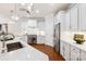 Elegant kitchen with stainless appliances, large island, modern lighting, and marble countertops at 10205 Alouette Dr, Waxhaw, NC 28173