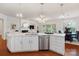Open concept living space with eat in kitchen island, stainless steel appliances, and hardwood floors at 10205 Alouette Dr, Waxhaw, NC 28173