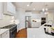 Bright kitchen features stainless steel appliances, white cabinetry, and marble countertops at 10205 Alouette Dr, Waxhaw, NC 28173