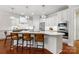 Contemporary kitchen with stainless steel appliances, white cabinets, and a large central island at 10205 Alouette Dr, Waxhaw, NC 28173