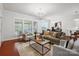 Well-lit living room with hardwood floors, neutral-toned furniture, and view to dining and kitchen at 10205 Alouette Dr, Waxhaw, NC 28173