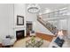 Grand living room with high ceilings, fireplace, staircase, hardwood floors, and natural light at 10205 Alouette Dr, Waxhaw, NC 28173