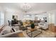 Bright open-plan living space with a modern kitchen, dining area, and comfortable seating at 10205 Alouette Dr, Waxhaw, NC 28173