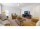 Inviting living room with comfortable seating, a ceiling fan, and a neutral color palette at 10205 Alouette Dr, Waxhaw, NC 28173