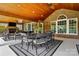 Spacious covered patio with an outdoor dining area, a fireplace, and ample seating at 10205 Alouette Dr, Waxhaw, NC 28173