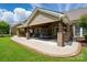 Expansive covered patio with an outdoor kitchen, dining, and seating area overlooking the backyard at 10205 Alouette Dr, Waxhaw, NC 28173