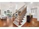 Elegant staircase with hardwood treads, wrought iron railings, and lots of natural light at 10205 Alouette Dr, Waxhaw, NC 28173