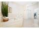 Bathroom showing large tub, shower, and white cabinets at 1245 Bellemeade Ln, Charlotte, NC 28270