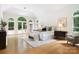 Bright main bedroom featuring hardwood floors, large windows with outdoor views, and a sitting area at 1245 Bellemeade Ln, Charlotte, NC 28270