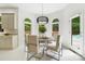 Dining area with a modern light fixture and natural light. The arched windows provide great views of the outdoor pool at 1245 Bellemeade Ln, Charlotte, NC 28270