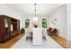 Elegant dining room featuring hardwood floors, built-in shelving, and large windows offering scenic backyard views at 1245 Bellemeade Ln, Charlotte, NC 28270