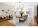 Open concept dining room with hardwood floors, modern decor, and large windows providing ample natural light and views at 1245 Bellemeade Ln, Charlotte, NC 28270