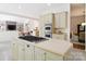 Kitchen with large center island and gas cooktop, stainless appliances, and open layout to living area for seamless entertaining at 1245 Bellemeade Ln, Charlotte, NC 28270