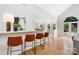 Open concept living area with hardwood floors, a bar with seating, and bright lighting throughout the space at 1245 Bellemeade Ln, Charlotte, NC 28270