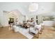 Expansive living room featuring hardwood floors, high ceilings, stylish seating arrangements and modern lighting at 1245 Bellemeade Ln, Charlotte, NC 28270