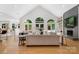Open living room with hardwood floors, large windows, vaulted ceiling, fireplace, and view of the pool at 1245 Bellemeade Ln, Charlotte, NC 28270