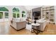 Bright living room featuring hardwood floors, a fireplace, built-in shelving, and two comfortable sofas at 1245 Bellemeade Ln, Charlotte, NC 28270