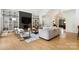 Spacious living room featuring hardwood floors, a fireplace, built-in shelving, and stylish seating at 1245 Bellemeade Ln, Charlotte, NC 28270