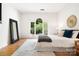 Stylish main bedroom featuring a beautiful large window with backyard views at 1245 Bellemeade Ln, Charlotte, NC 28270