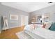 Main bedroom featuring a light gray accent wall and ensuite bathroom access at 1245 Bellemeade Ln, Charlotte, NC 28270